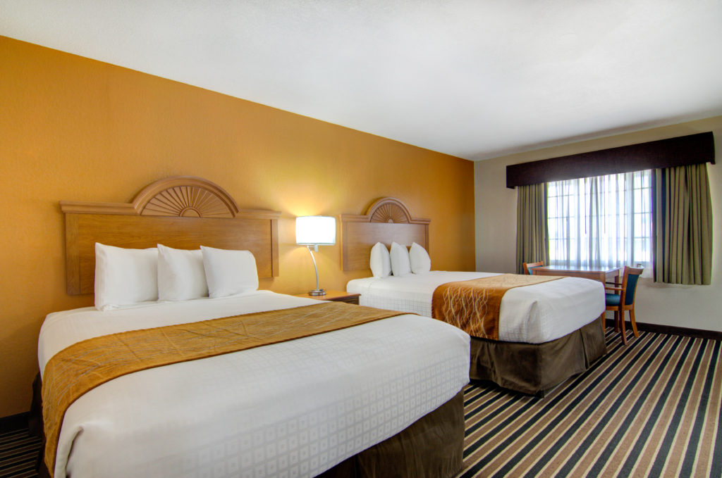 Three-Bedroom Family Suite with three full-size beds at Westbridge Inn & Suites